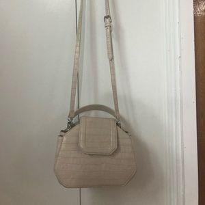 Cream coloured faux leather purse.